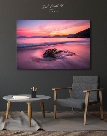 Rock in a Wavy Sea under an Orange and Pink Sky at Sunset Canvas Wall Art - image 3